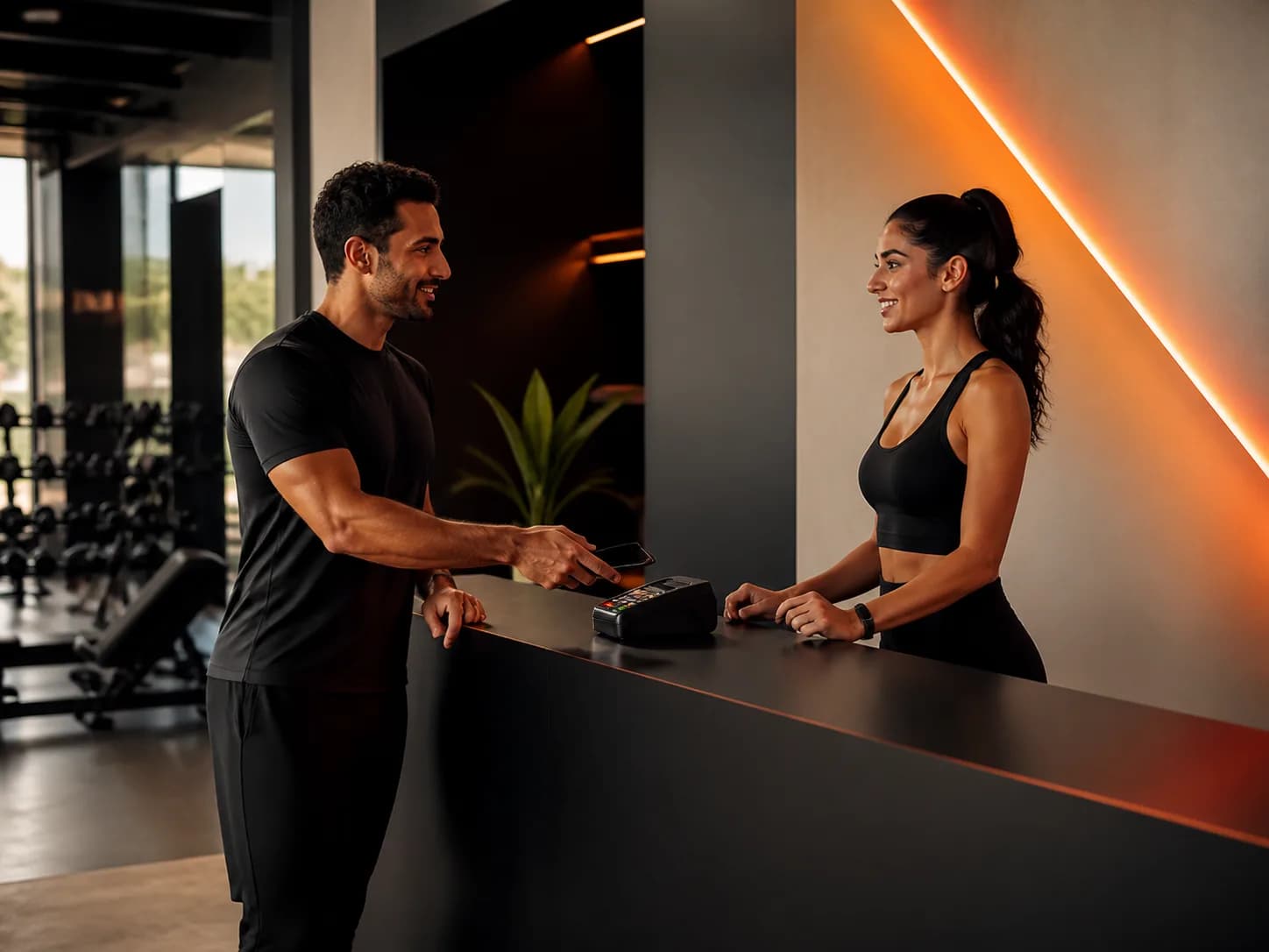 A member completing a payment at a fitness club